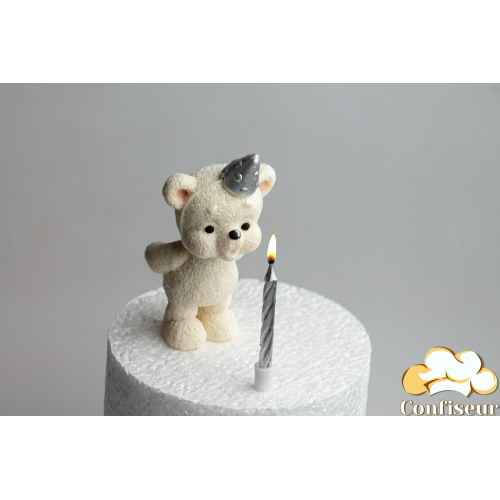 Chocolate figurine "White bear with silver cap blowing out a candle" with a candle