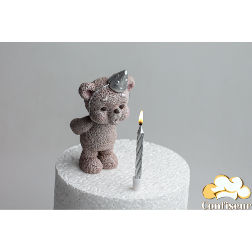 Chocolate figurine "Toffee Bear Silver Cap Blowing Out a Candle" with a candle