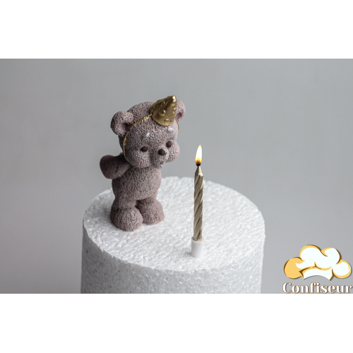 Chocolate figurine "Toffee Bear Golden Cap Blowing Out a Candle" with a candle